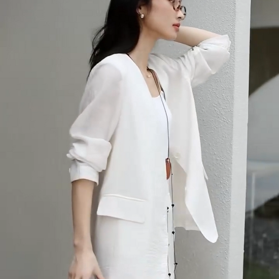 Video showcasing a Women's textured pinstripe crinkle blazer in Pearl Bush, hip-length with a clean V-neckline, defined by freedom. From Borcelleclothes.