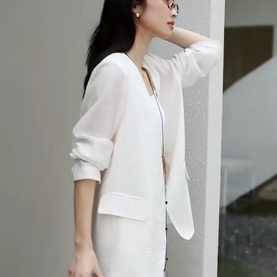 Video showcasing a Women's textured pinstripe crinkle blazer in Pearl Bush, hip-length with a clean V-neckline, defined by freedom. From Borcelleclothes.