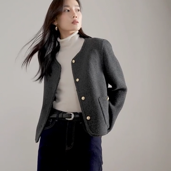 Video showcasing a Women's double-sided virgin wool jacket in Perle Noir and Tumbled Shell colors. Features include gold-tone embossed buttons, patch pockets, and hand-made Wave Stitch finishing along the edges. — From Borcelleclothes.