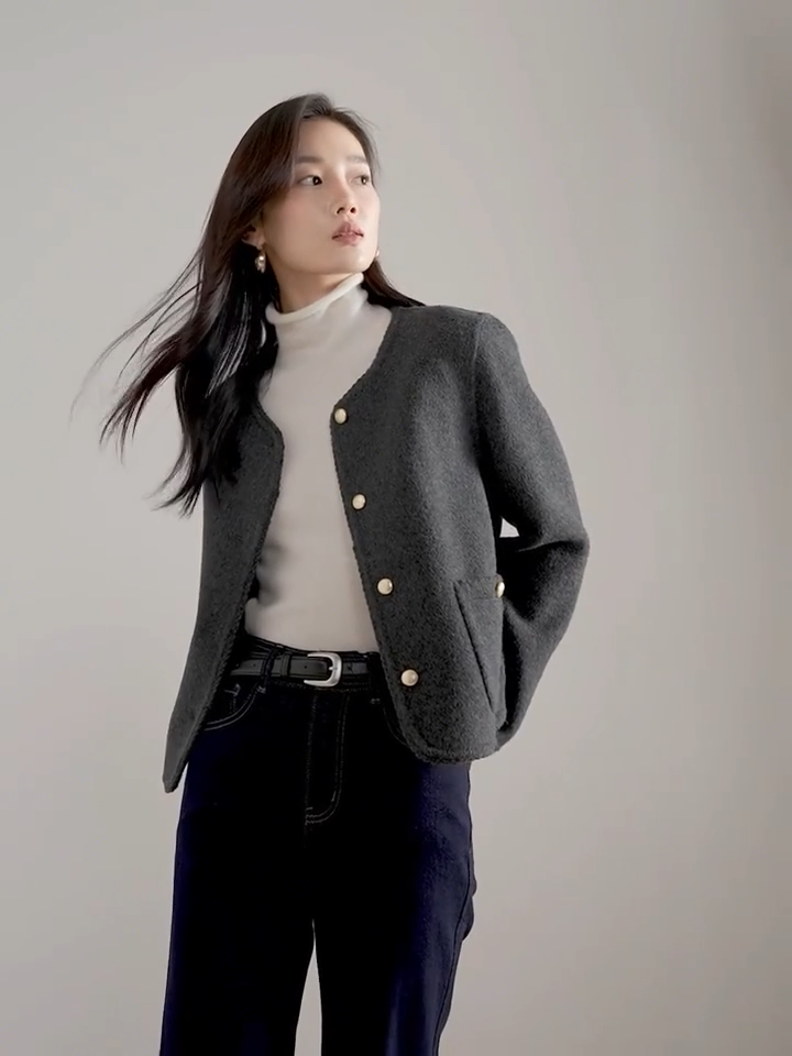 Video showcasing a Women's double-sided virgin wool jacket in Perle Noir and Tumbled Shell colors. Features include gold-tone embossed buttons, patch pockets, and hand-made Wave Stitch finishing along the edges. — From Borcelleclothes.
