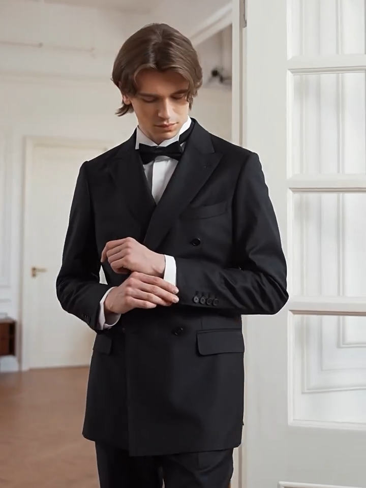 Video showcasing a Men's Sartorial double-breasted suit in Vitale Barberis Canonico twill wool. Designed with a half-canvas build, sculpted shoulders, and tapered pleated trousers. — From Borcelleclothes.