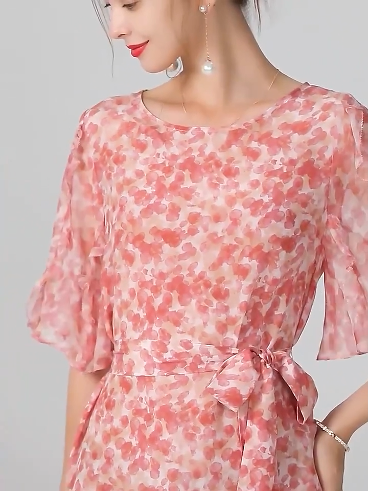 Video showcasing a Mulberry silk chiffon dress with abstract floral print in rose tones, featuring a round neckline, matching belt, and softly flowing volume. From Borcelleclothes.