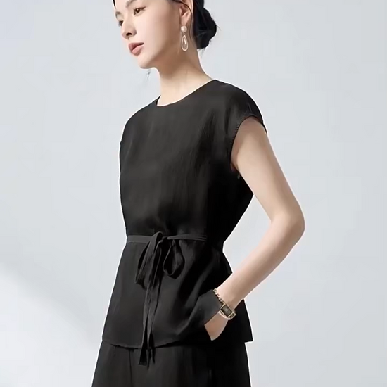 Video showcasing a Women's Silk blouse in Queen of Spades. Crafted from sand-washed 19 Momme Mulberry Silk with a 3D jacquard crepe texture and defined sash waist. — From Borcelleclothes.