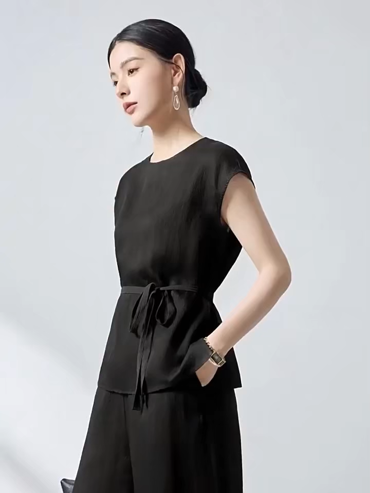 Video showcasing a Women's Silk blouse in Queen of Spades. Crafted from sand-washed 19 Momme Mulberry Silk with a 3D jacquard crepe texture and defined sash waist. — From Borcelleclothes.
