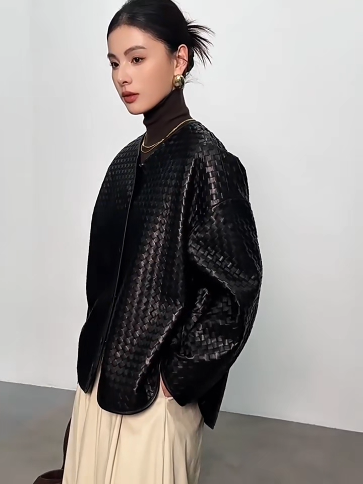 Video showcasing a Women's Sculptural hand-woven sheepskin nappa jacket in Quicksilver Noir. Featuring diagonal geometric weaving, relaxed silhouette, and curved leather-bound edges. — From Borcelleclothes.