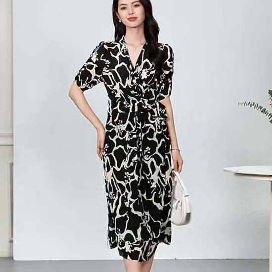 Video showcasing a Women's midi-length wrap silk dress in Rorschach Inkblot Test color features a wrap V-neckline, 1/3 sleeves with gathered cuffs, and front box pleats on the skirt. — From Borcelleclothes.