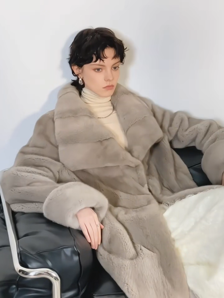Video showcasing a Women's Mid-calf coat in Smokey Quarts, crafted from premium Kopenhagen sheared mink fur, featuring a flared silhouette, wide lapels, drawstring waist, and turn-back cuffs — From Borcelleclothes.