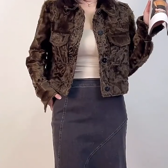 Video showcasing a Women's cropped shearling shirt-jacket in Star Anise, featuring waved Xiaohu fleece, pointed collar, and military shoulder tabs. - From Borcelleclothes.