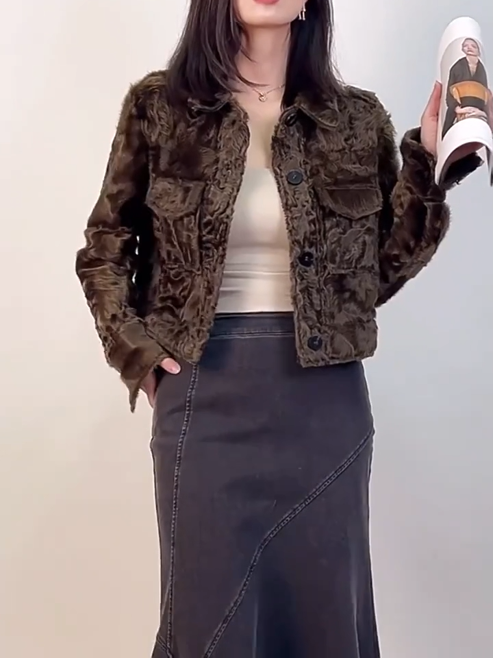 Video showcasing a Women's cropped shearling shirt-jacket in Star Anise, featuring waved Xiaohu fleece, pointed collar, and military shoulder tabs. - From Borcelleclothes.
