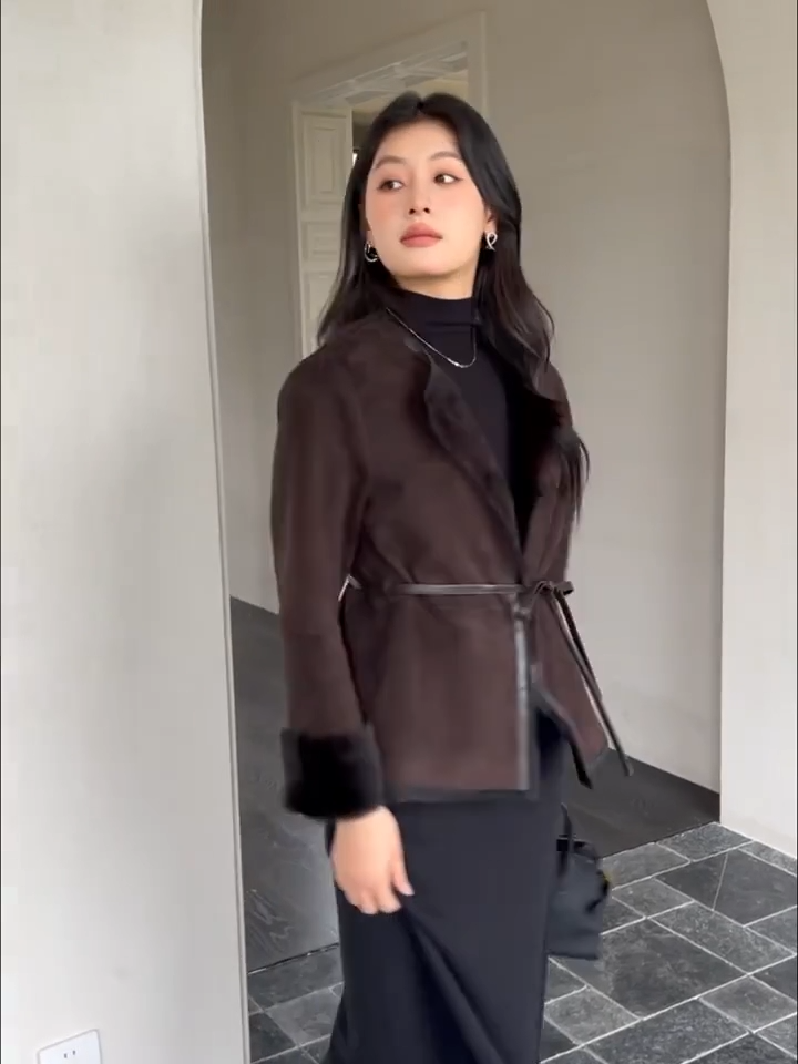 Video showcasing a Women’s slim-fit goatskin jacket in Tamarind with round neckline, leather-bound edges, and full inner wool — From Borcelleclothes.