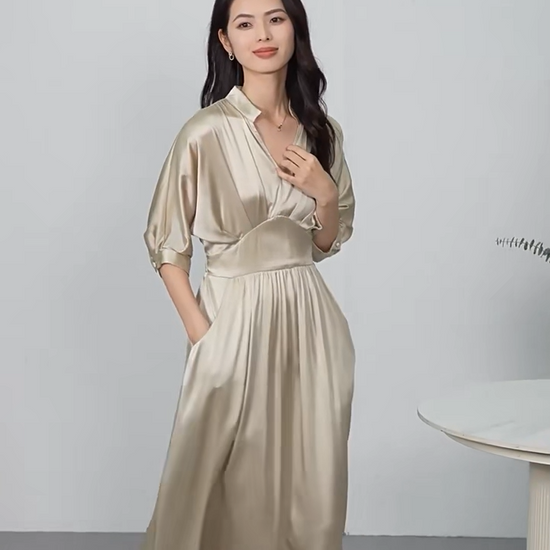 Video showcasing a midi-length Mulberry silk satin dress in Taste of Champagne and Hot Ice colors, with a stand-up collar, V-neckline, and elegant pleated waist detail. — From Borcelleclothes.