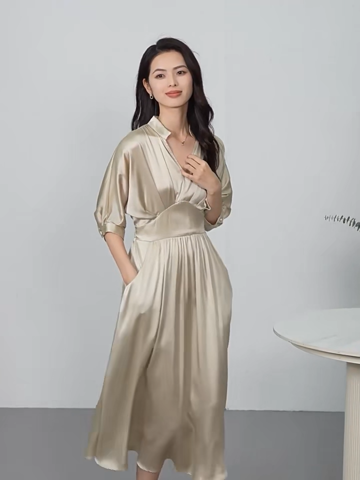 Video showcasing a midi-length Mulberry silk satin dress in Taste of Champagne and Hot Ice colors, with a stand-up collar, V-neckline, and elegant pleated waist detail. — From Borcelleclothes.