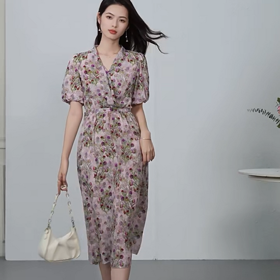 Video showcasing a Women's Midi wrap dress in 100% Mulberry silk crepe de chine. Featuring the "Thistle Grace" print, draping pleats at the waist, and a functional sash casing. Sleeves are tucked inward for a soft frame. — From Borcelleclothes.