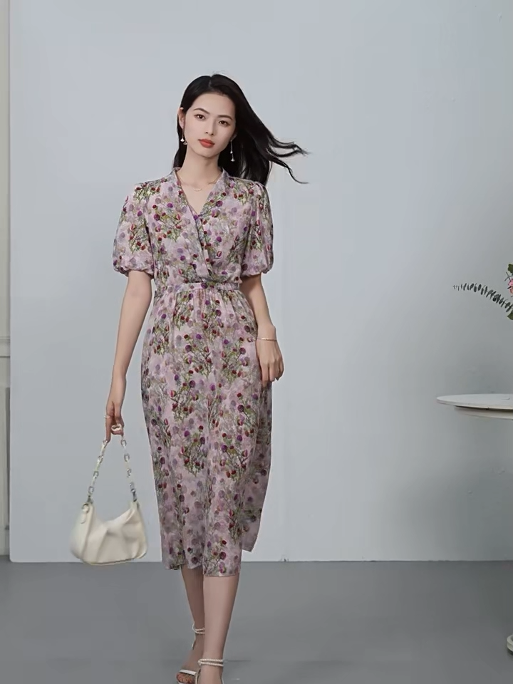Video showcasing a Women's Midi wrap dress in 100% Mulberry silk crepe de chine. Featuring the "Thistle Grace" print, draping pleats at the waist, and a functional sash casing. Sleeves are tucked inward for a soft frame. — From Borcelleclothes.