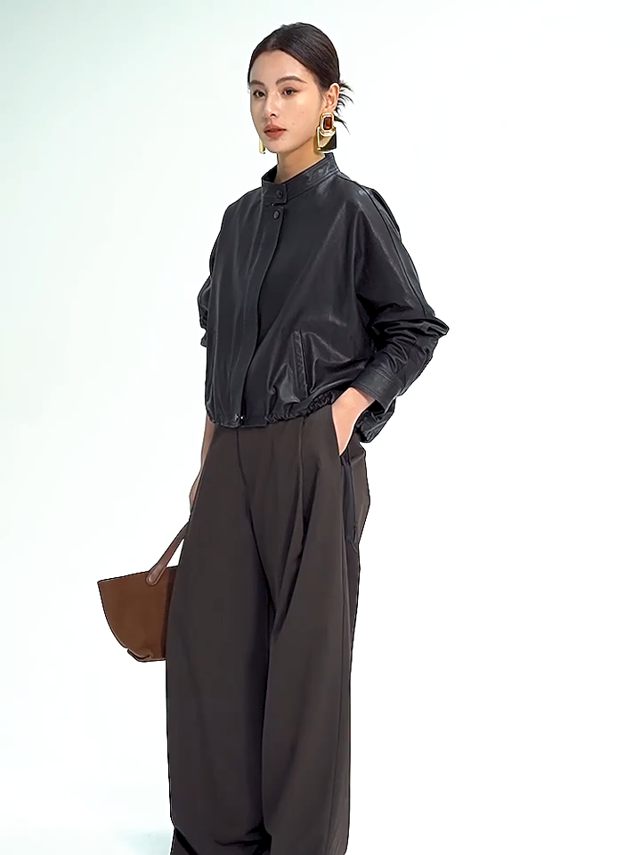 Video showcasing a Women's Cropped artisan vegetable-tanned sheepskin jacket in Ti Guardo Adesso. Featuring a band collar, draped kimono sleeves, and side drawstrings. — From Borcelleclothes.
