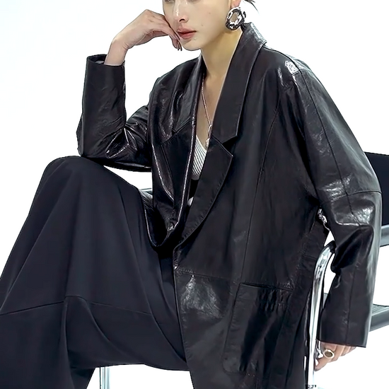 Video showcasing a Women's Glazed goatskin nappa wrap jacket in Vola Con Me. Tailored with low-notch lapels, tapering kimono sleeves, and the fluid drape of heavy silk. — From Borcelleclothes.