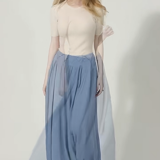 Video showcasing a Women's heavyweight 6A Grade Mulberry Silk skirt in Wandering River, featuring a sculptural arched inset panel construction and an innovative, geometric tiered facing. — From Borcelleclothes.