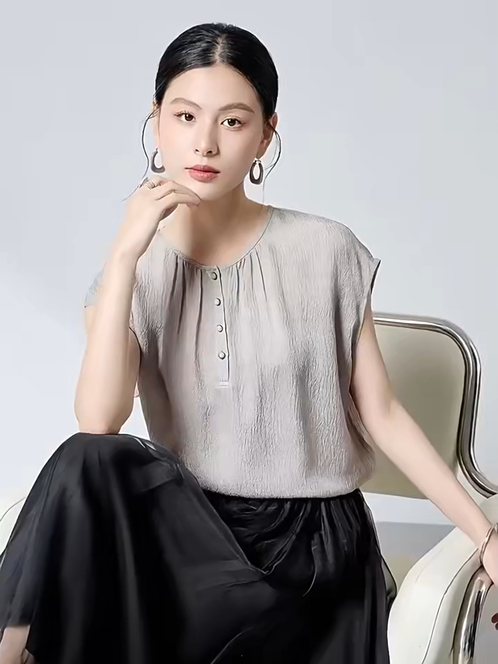 Video showcasing a Women's Loose-fitting 14 Momme Mulberry silk georgette blouse in Where Lives Nacre, with a micro-puckered jacquard texture. Features a Henley placket with mother-of-pearl cabochon buttons. — From Borcelleclothes.
