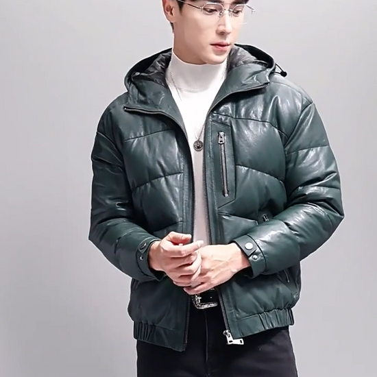 Video showcasing a Men's sheepskin down jacket with zipper chest and side pockets, elastic cuffs, and a hood with drawcord — shown in Winter Balsam color — From Borcelleclothes.