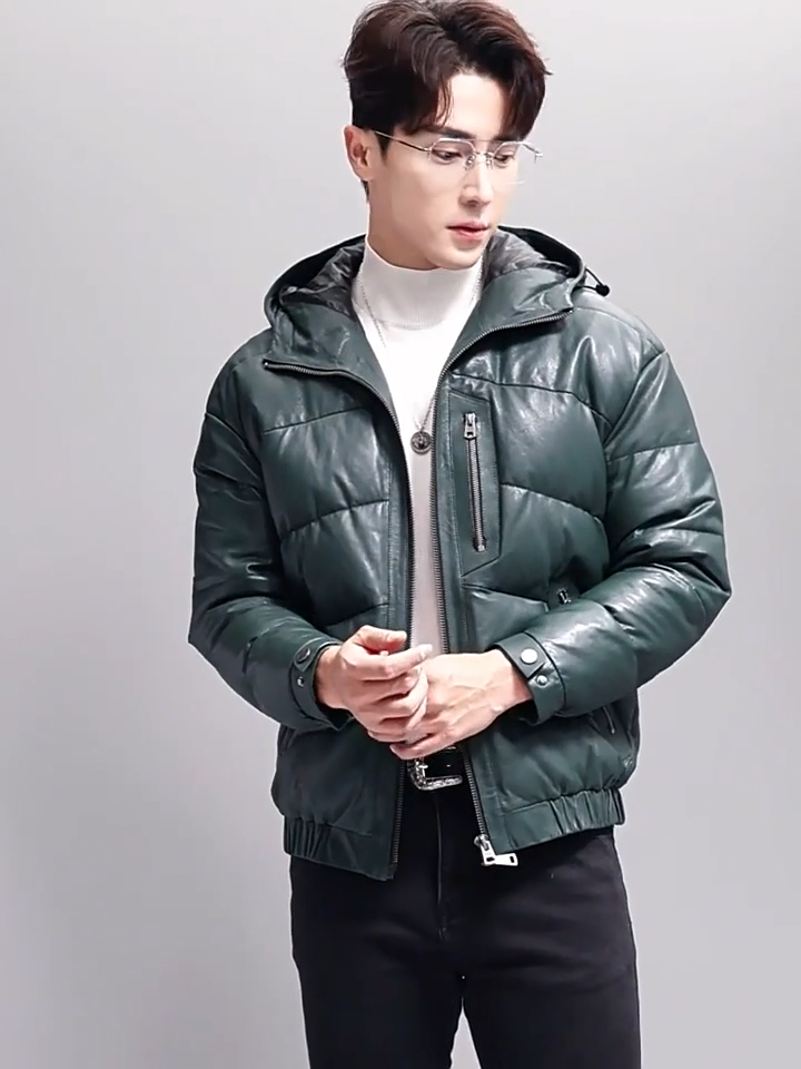 Video showcasing a Men's sheepskin down jacket with zipper chest and side pockets, elastic cuffs, and a hood with drawcord — shown in Winter Balsam color — From Borcelleclothes.