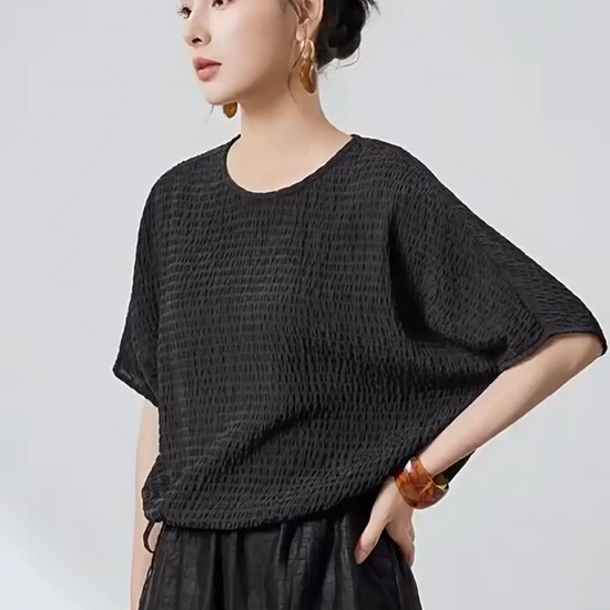 Video showcasing a Women's Wrinkle-resistant Mulberry silk blouse in textured 3D stripes and Without Pressure color. Features batwing sleeves, a round neckline, and an adjustable hem. —From Borcelleclothes.