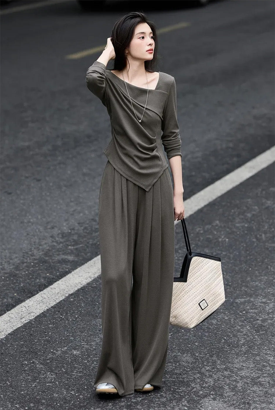 Woman in a diagonal-collar ribbed knit set adjusting her hair, side view — From Borcelleclothes.