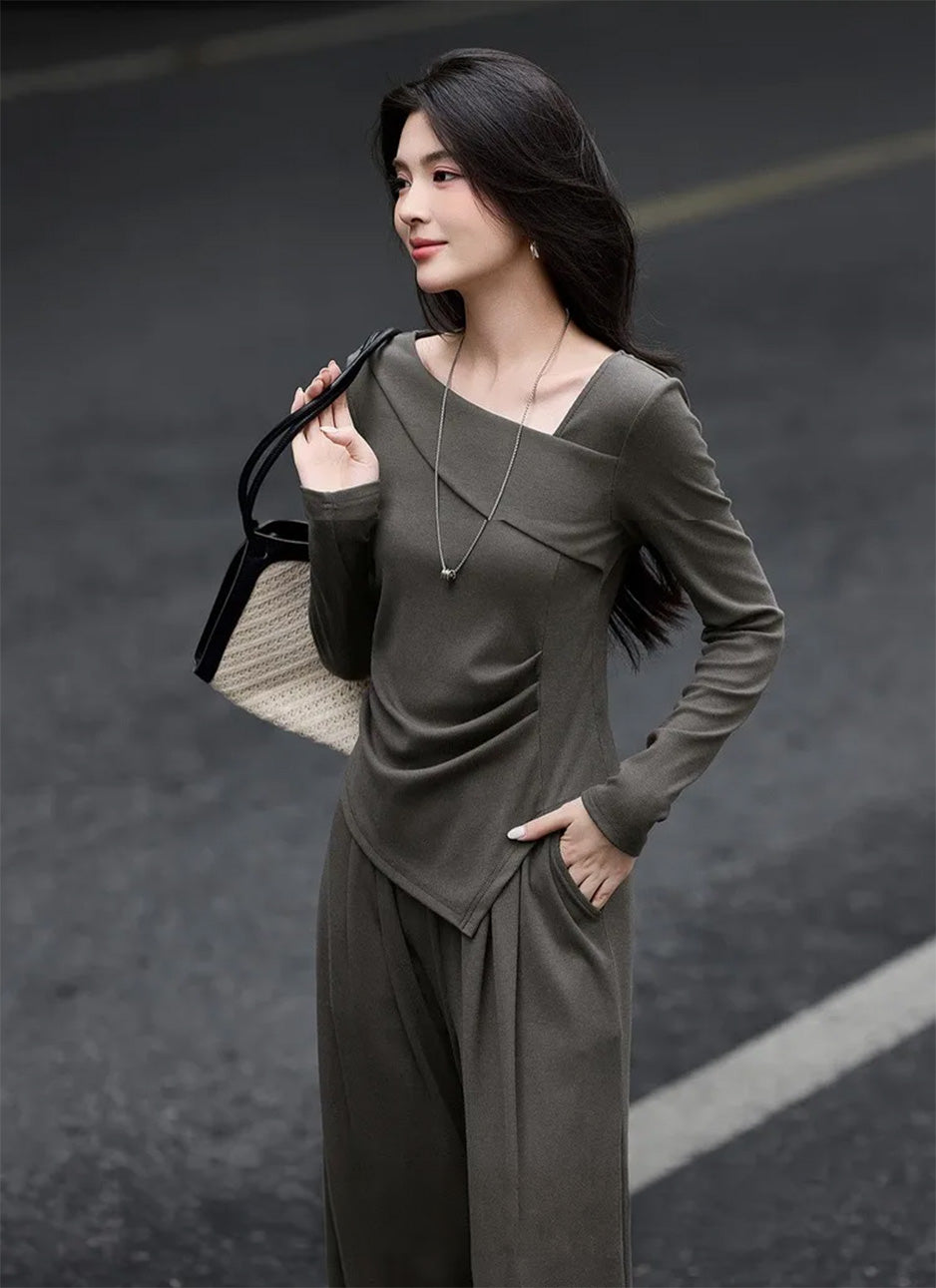 Woman posing with a hand in her pants pocket and a bag over her shoulder in a ribbed set — From Borcelleclothes.