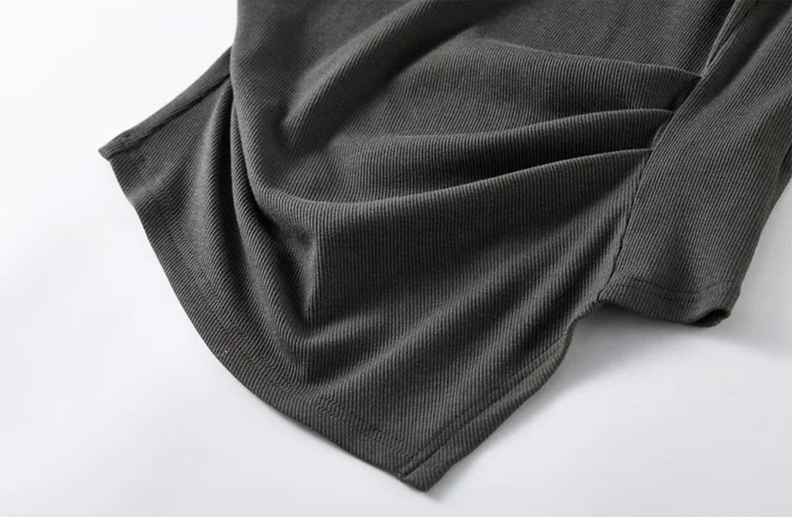 Close-up of the angled asymmetrical high-low hem on a woman’s ribbed top — From Borcelleclothes.