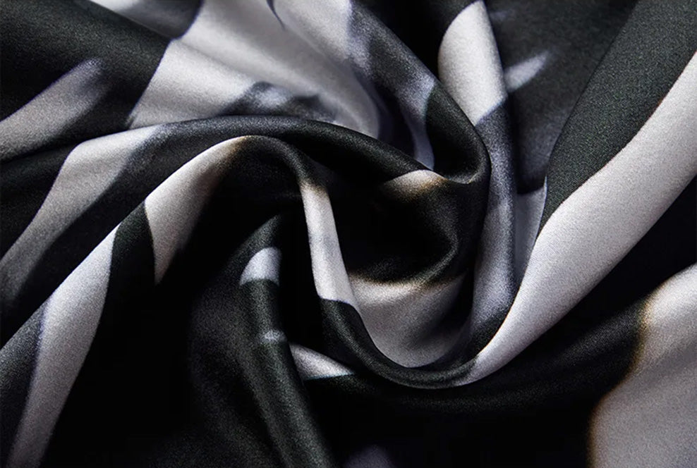Spiral-folded Mulberry silk satin showcasing the Fleeting Impulse print — From Borcelleclothes.