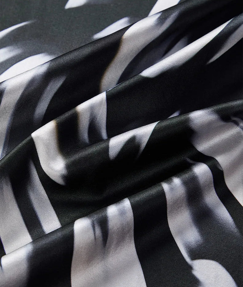 Wave-folded texture of Mulberry silk satin in Fleeting Impulse print — From Borcelleclothes.