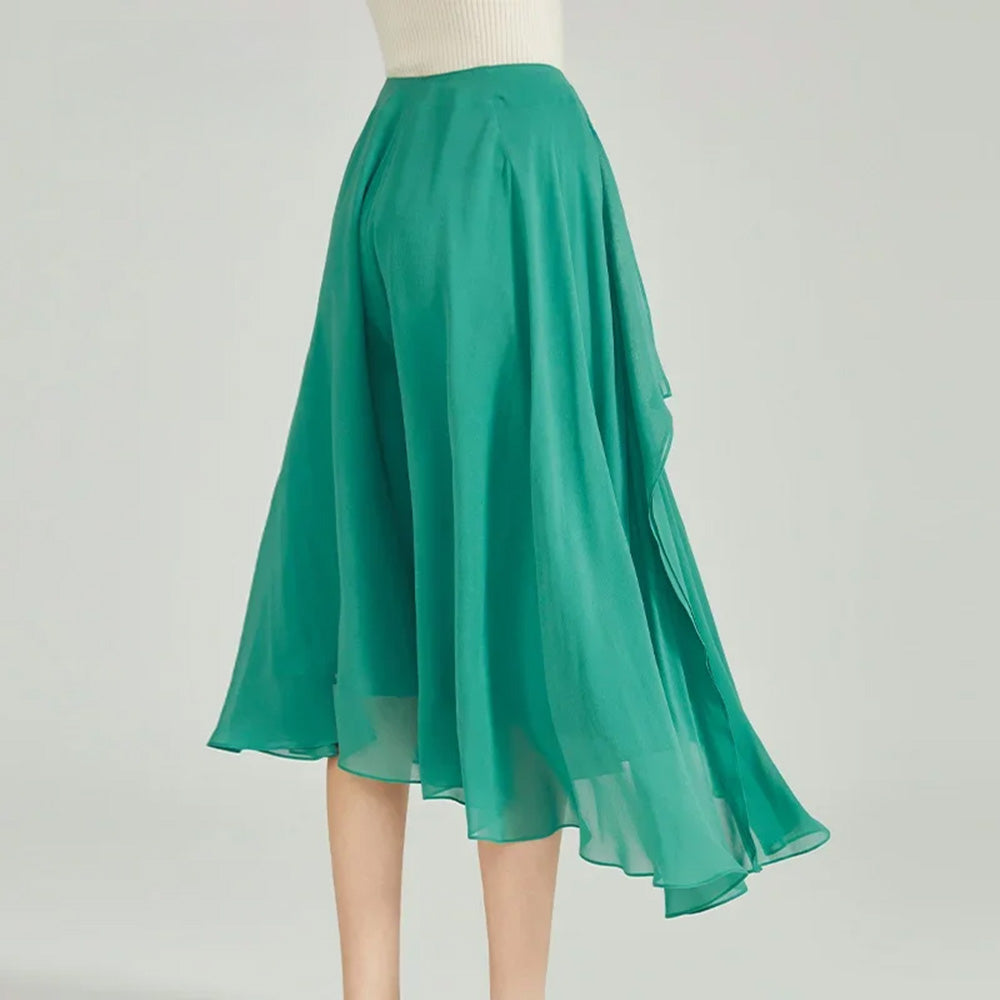Back perspective of model showcasing the fluid, free-falling draped hem on silk trousers — From Borcelleclothes
