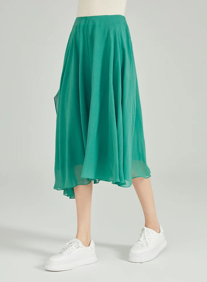 Side view of model stepped out, highlighting the fluid right-leg handkerchief cascade — From Borcelleclothes.