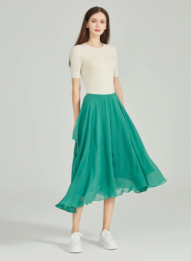 Model in asymmetrical silk georgette trousers showing a swirling, skirt-like hem in motion — From Borcelleclothes.