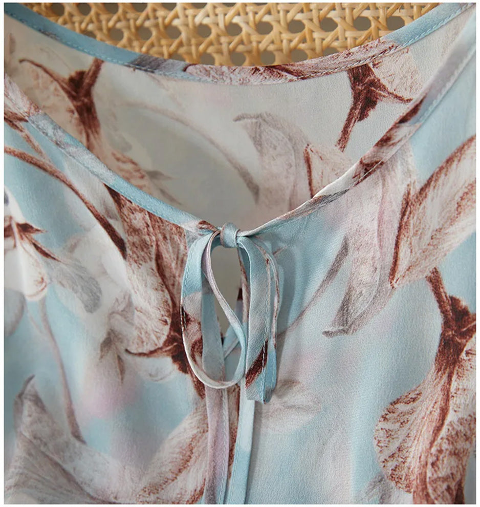 Close-up of the elegant neckline and delicate ties on the celestial blue silk dress — From Borcelleclothes.