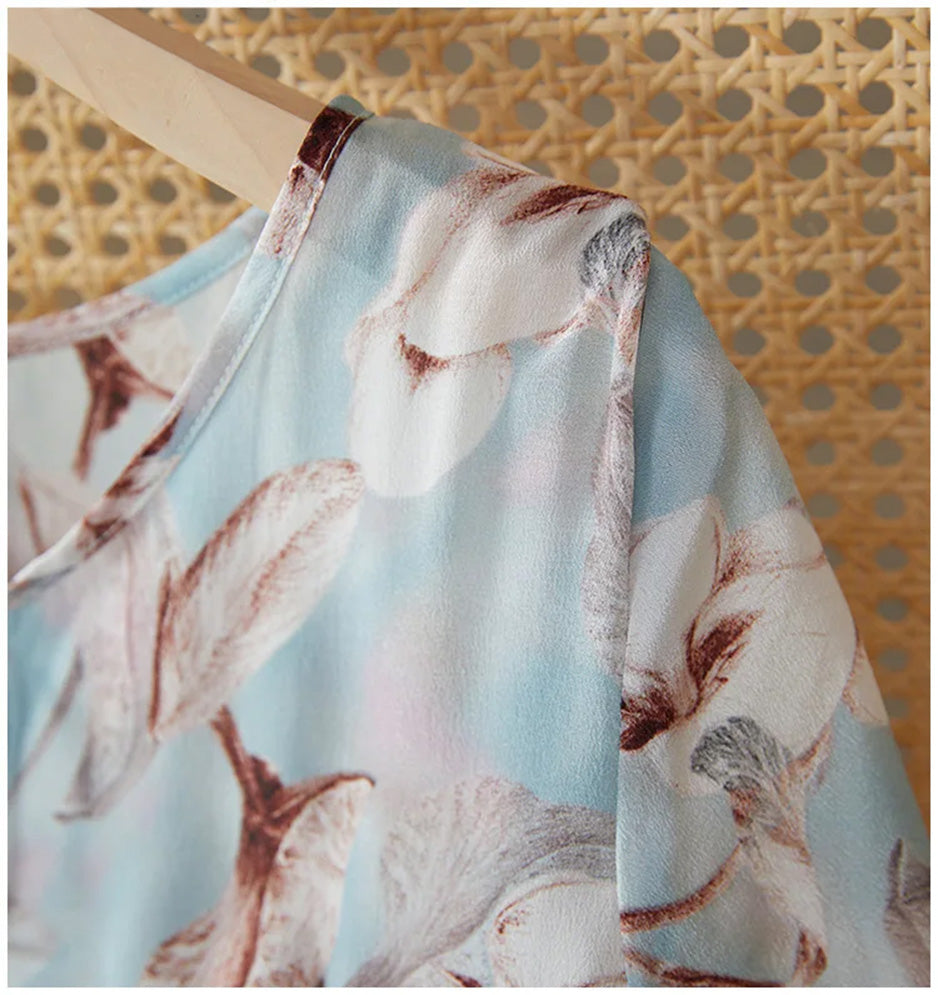 Close-up of the shoulder and delicate flutter sleeve catching the air on the Celestial Bauhinia silk dress — From Borcelleclothes.