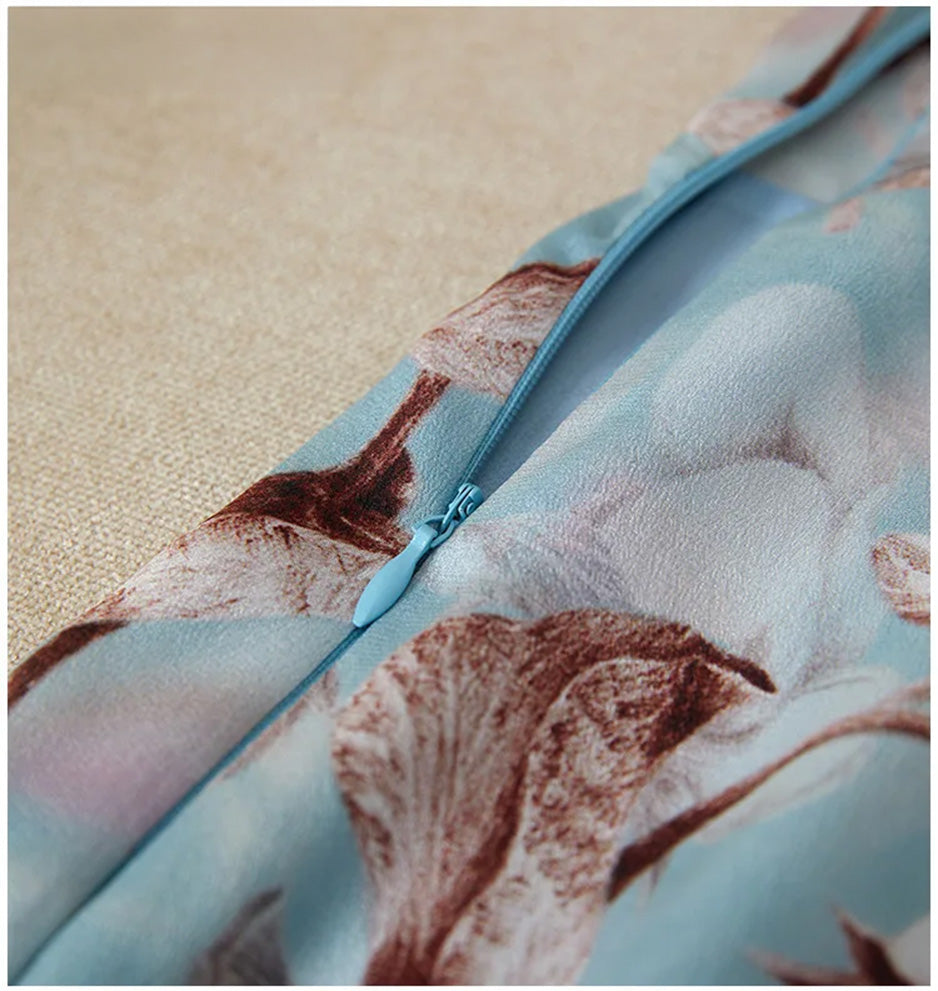 Close-up of the seamlessly integrated, slightly unzipped hidden zipper on the silk dress — From Borcelleclothes.