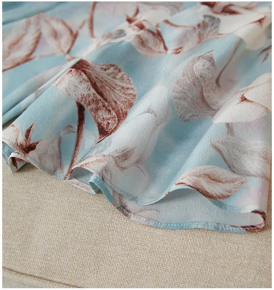 Detailed view of the fluid, wave-curved flounces at the bottom hem of the Celestial Bauhinia silk dress — From Borcelleclothes.