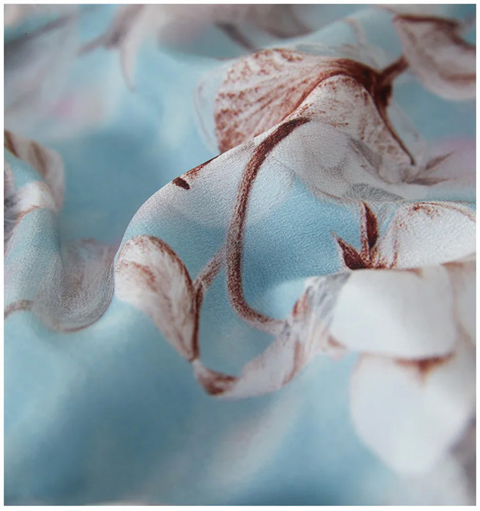 Close-up of the wave-folded texture of 100% crepe de chine silk in the exclusive Celestial Bauhinia print — From Borcelleclothes.
