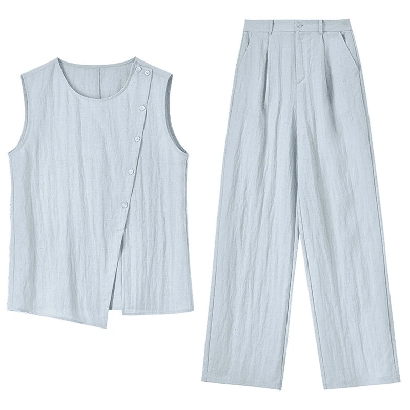 Flat-lay view of the light blue asymmetrical top and wide-leg trousers set, showcasing the design architecture — From Borcelleclothes.