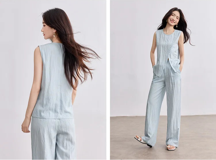 Collage showing a woman from the front and back in a coordinated light blue trousers set, highlighting the asymmetrical drape — From Borcelleclothes.