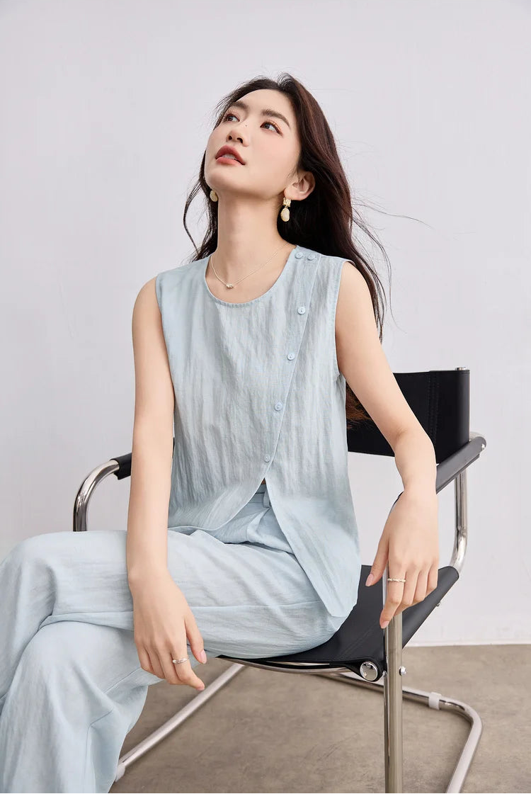 A woman sitting comfortably and looking upward, styled in a minimalist blue Lyocell-linen coordinated set — From Borcelleclothes.