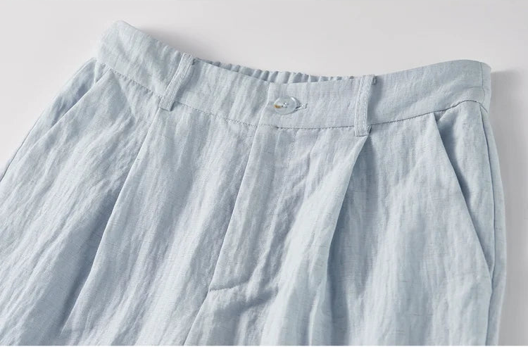 Focus on the upper section of the trousers, highlighting the two front pleats and side slash pockets — From Borcelleclothes.