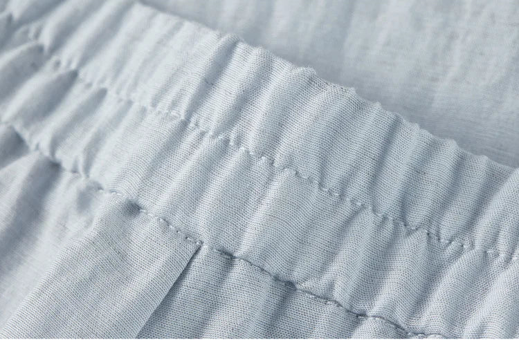 Close-up of the back of the trousers, showing the ribbed elastic waistband for adjustable comfort — From Borcelleclothes.