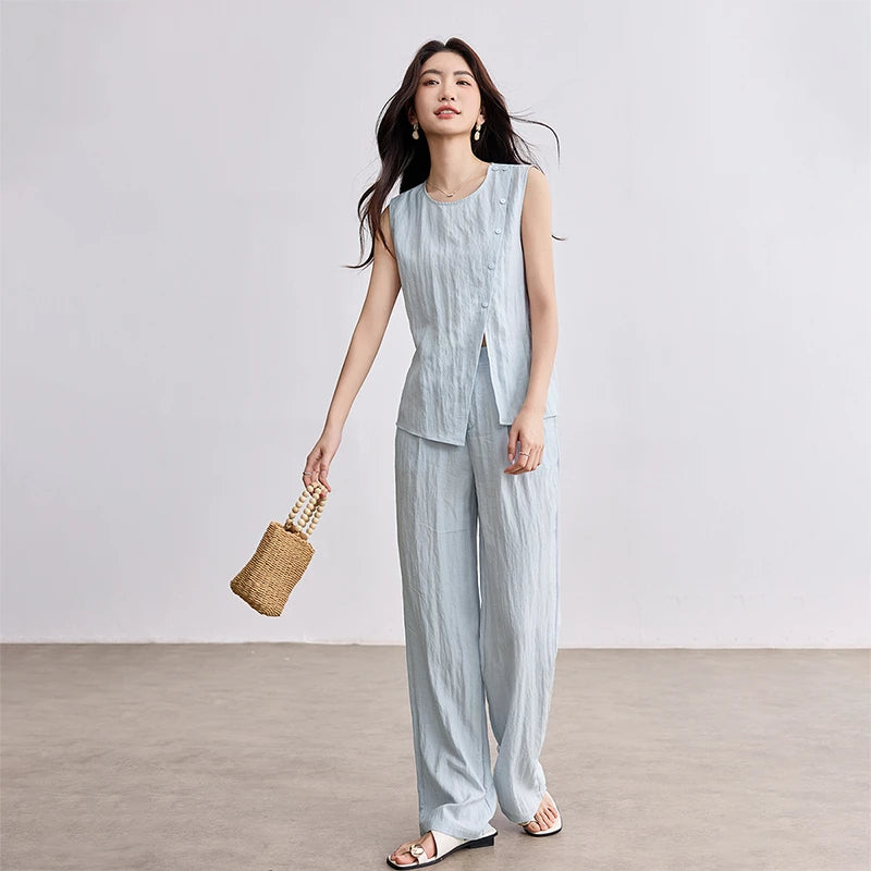 Women's light blue asymmetrical wrap top and matching wide-leg pleated trousers in a crinkled linen-lyocell blend. — From Borcelleclothes.