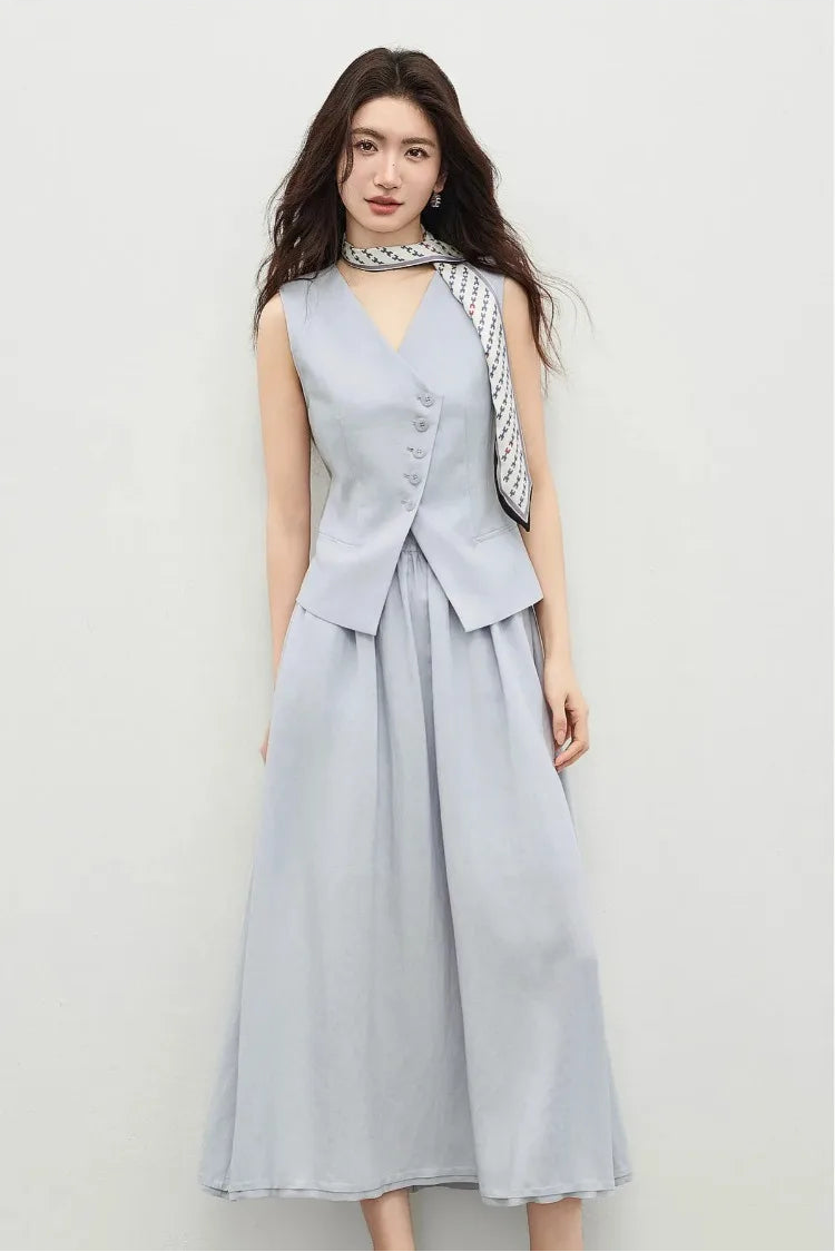 Woman in a lavender flared midi skirt and asymmetrical vest, captured in a dynamic pose with a bent leg — From Borcelleclothes.