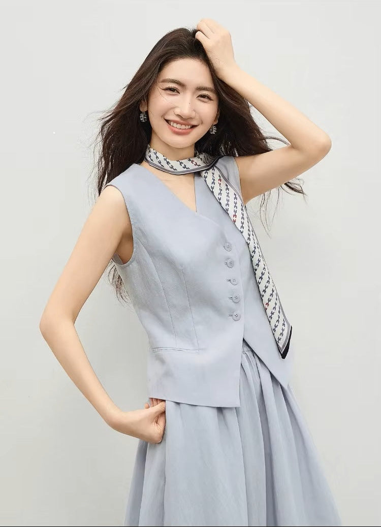 Woman posing in a lavender two-piece set featuring a wrap V-neckline and contrast scarf detail — From Borcelleclothes.