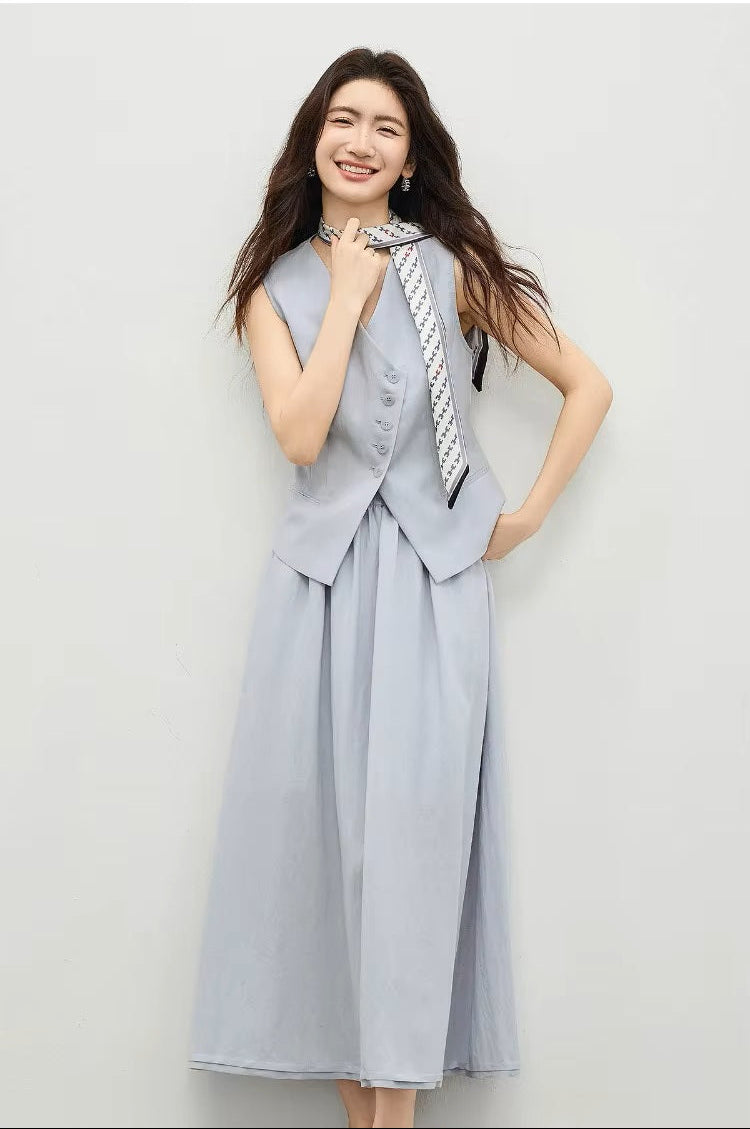 Woman wearing a lavender tailored vest and skirt, hand on hip with scarf detail — From Borcelleclothes.