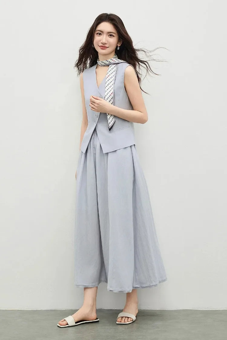 Side view of a woman in a lavender slim-fitting vest and flared midi skirt — From Borcelleclothes.