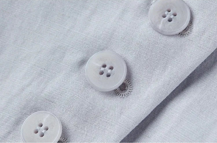 Detail shot of the five tonal buttons on the single-breasted asymmetrical vest — From Borcelleclothes.