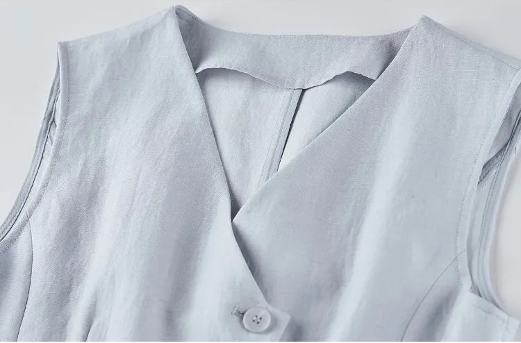 Close-up of the vest's upper section, showing the wrap V-neck and tonal buttons — From Borcelleclothes.